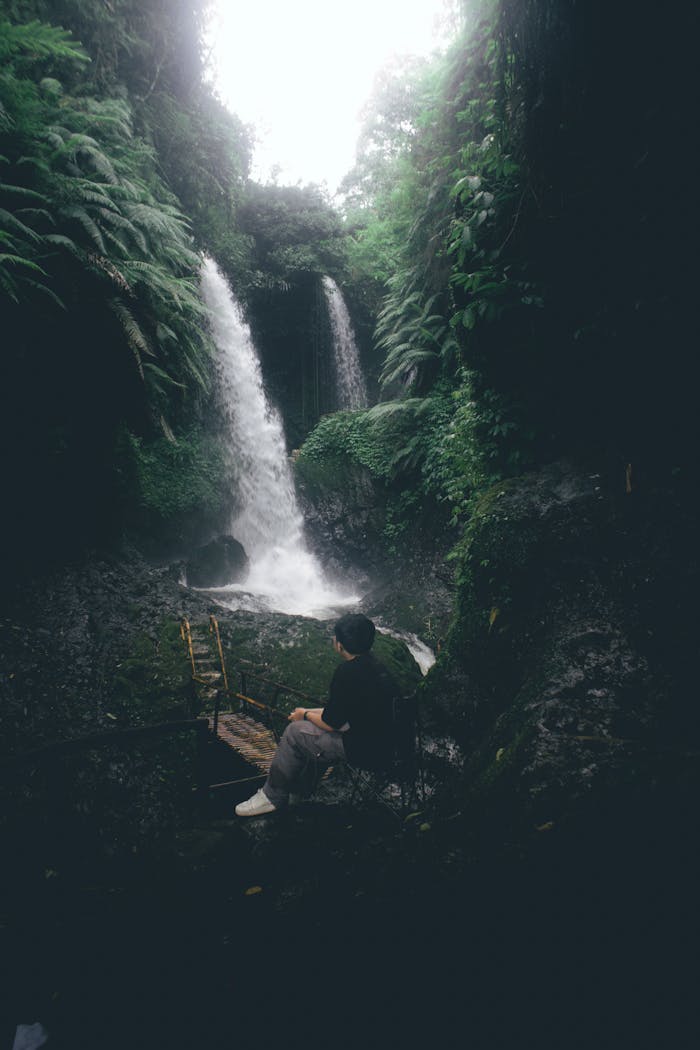 Explore tranquility at a stunning twin waterfall amidst lush greenery in Bandung, Indonesia.